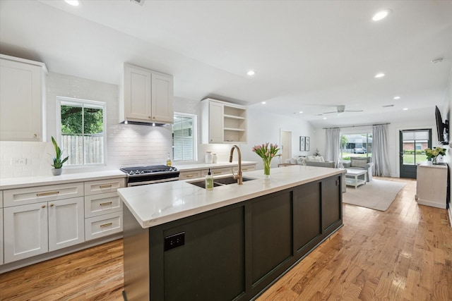 2218 Gardenia Dr, Houston, TX 77018 - kitchen featuring a sink, white cabinets, stainless steel gas range oven, healthy amount of natural light, and recessed lighting