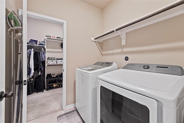399 Black Walnut Dr, Conroe, TX 77304 - laundry area featuring washing machine and dryer, carpet floors, and tile patterned flooring