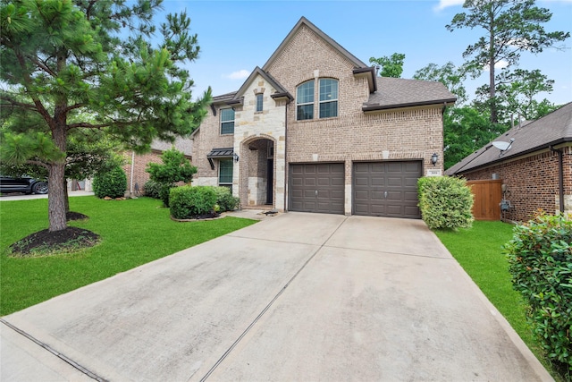 399 Black Walnut Dr, Conroe, TX 77304 - french country home with brick siding, concrete driveway, and an attached garage