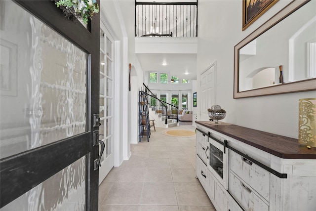 399 Black Walnut Dr, Conroe, TX 77304 - foyer entrance with a towering ceiling, light tile patterned floors, baseboards, and french doors