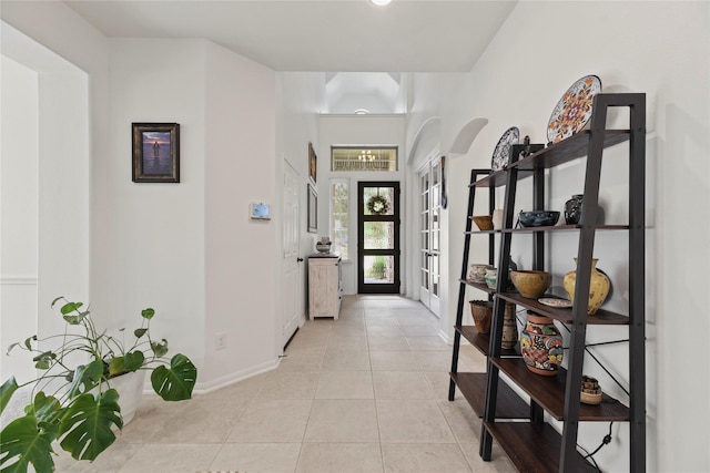 399 Black Walnut Dr, Conroe, TX 77304 - foyer entrance featuring arched walkways, baseboards, and light tile patterned floors
