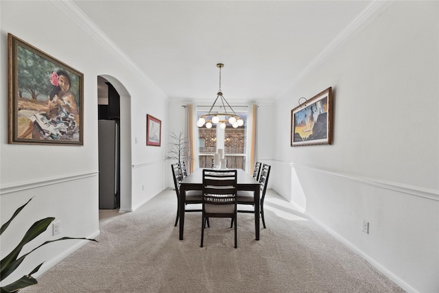 399 Black Walnut Dr, Conroe, TX 77304 - dining space with crown molding, a chandelier, light carpet, arched walkways, and baseboards