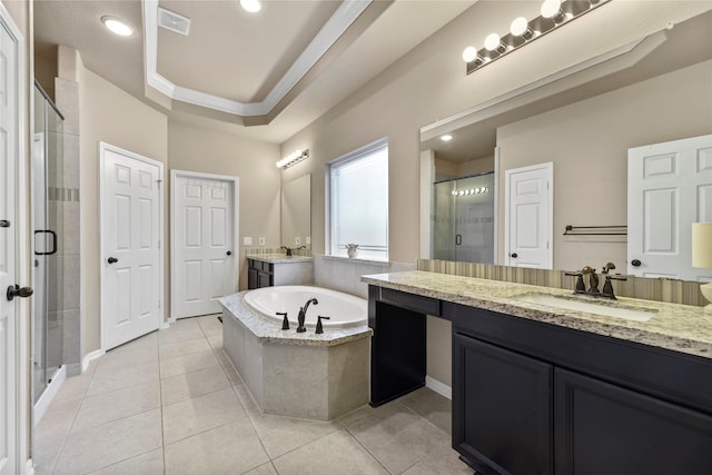 399 Black Walnut Dr, Conroe, TX 77304 - full bath with two vanities, a shower stall, a garden tub, tile patterned flooring, and baseboards