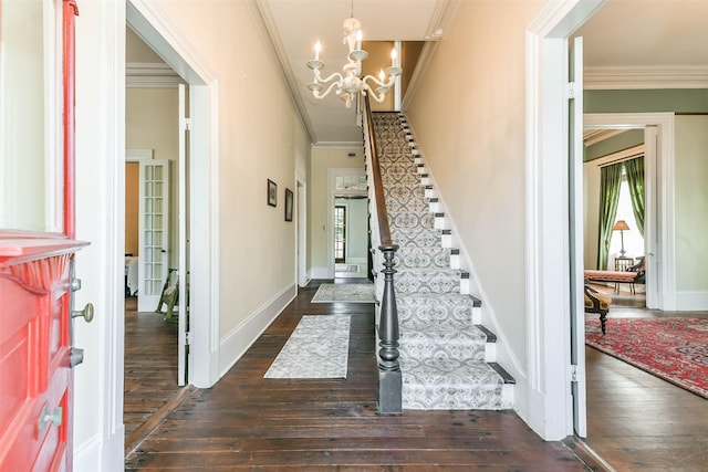 1309 Broadway St, Galveston, TX 77550 - entrance foyer with crown molding, dark wood-style flooring, stairs, a chandelier, and baseboards