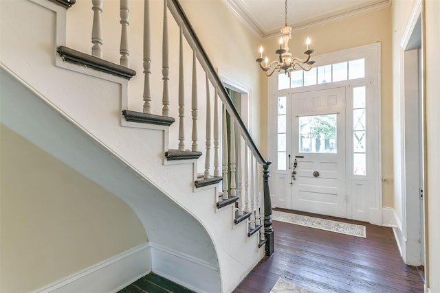 1309 Broadway St, Galveston, TX 77550 - foyer entrance with a chandelier, ornamental molding, stairs, and dark wood finished floors