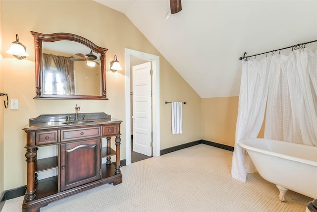 1309 Broadway St, Galveston, TX 77550 - bathroom featuring lofted ceiling, a freestanding tub, vanity, and baseboards