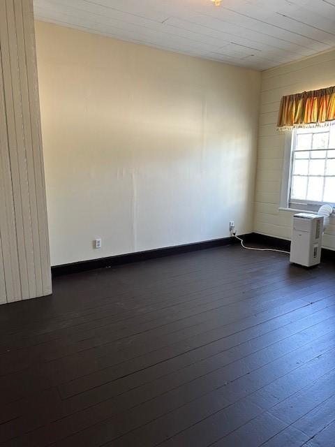 1309 Broadway St, Galveston, TX 77550 - spare room featuring dark wood-style flooring and baseboards