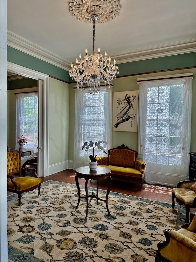 1309 Broadway St, Galveston, TX 77550 - living area featuring a chandelier, crown molding, wood finished floors, and baseboards