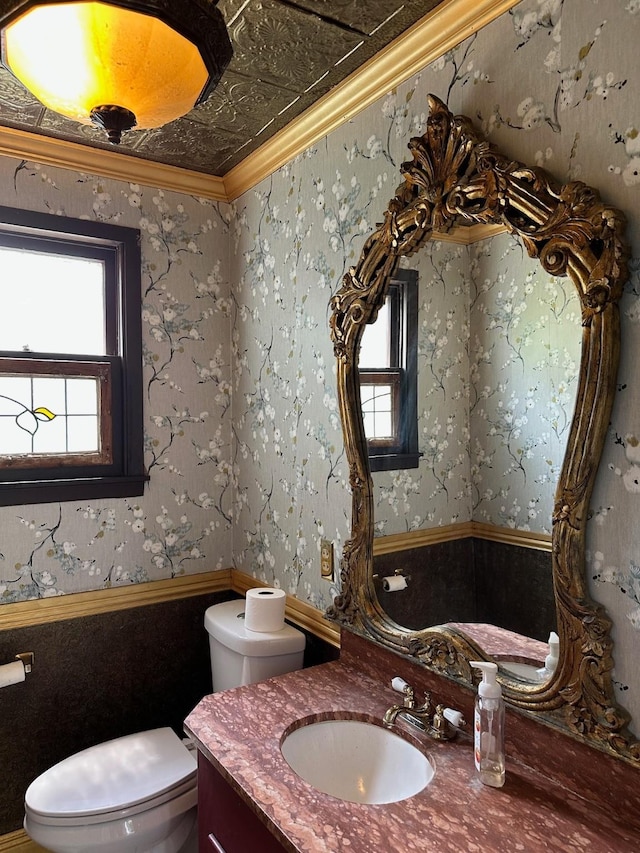 1309 Broadway St, Galveston, TX 77550 - half bathroom featuring toilet, plenty of natural light, crown molding, and vanity