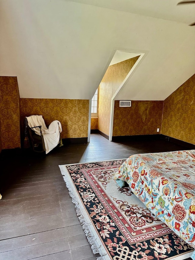 1309 Broadway St, Galveston, TX 77550 - bedroom featuring hardwood / wood-style flooring, wallpapered walls, lofted ceiling, and baseboards