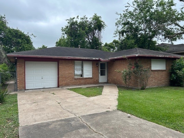 6619 Carver Ave, Hitchcock, TX 77563 - ranch-style house with brick siding, an attached garage, driveway, and a front yard