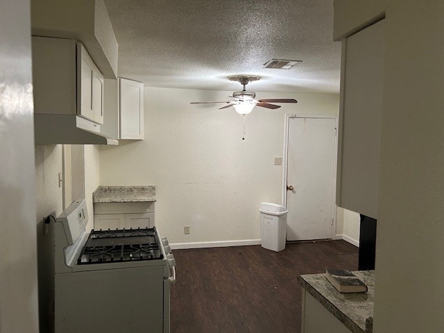 6619 Carver Ave, Hitchcock, TX 77563 - kitchen with white gas range, ceiling fan, baseboards, dark wood-type flooring, and a textured ceiling