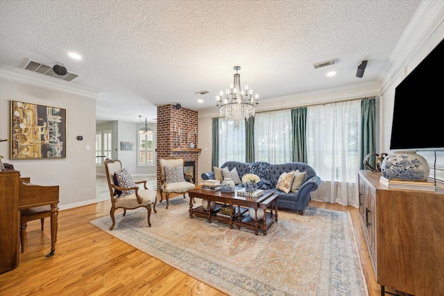 19 Remington Park, Katy, TX 77493 - living area with a chandelier, a textured ceiling, crown molding, light wood-type flooring, and baseboards