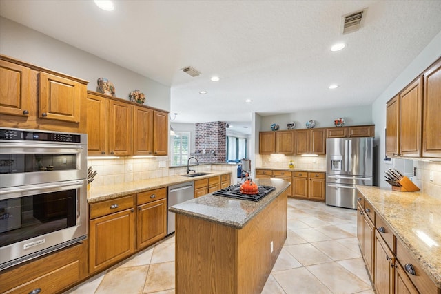 19 Remington Park, Katy, TX 77493 - kitchen featuring stainless steel appliances, a sink, a kitchen island, backsplash, and recessed lighting