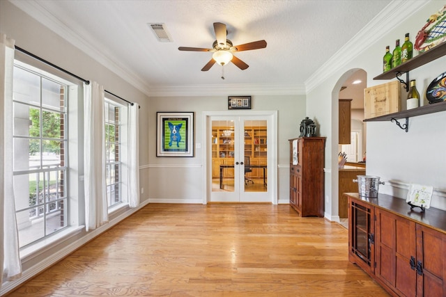 19 Remington Park, Katy, TX 77493 - interior space with french doors, a ceiling fan, light wood finished floors, arched walkways, and crown molding
