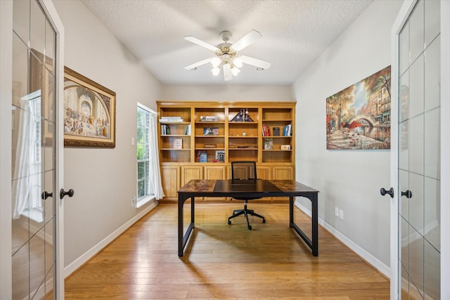 19 Remington Park, Katy, TX 77493 - office area with french doors, light wood-style floors, a ceiling fan, a textured ceiling, and baseboards