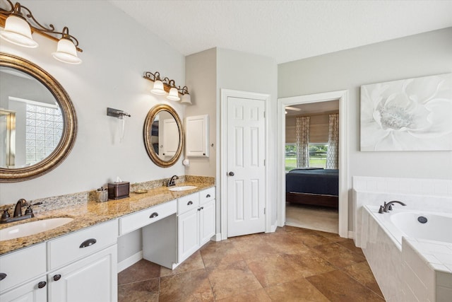 19 Remington Park, Katy, TX 77493 - bathroom featuring double vanity, a bath, and baseboards