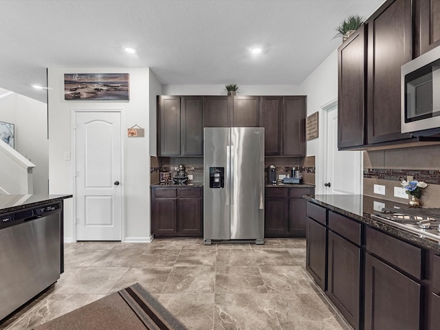 14306 Cedar Pine Ct, Houston, TX 77068 - kitchen with appliances with stainless steel finishes, dark brown cabinets, dark stone counters, and recessed lighting