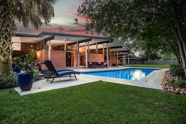 1240 Oakcrest Cir, Beaumont, TX 77706 - back of property at dusk with a patio and an outdoor living space