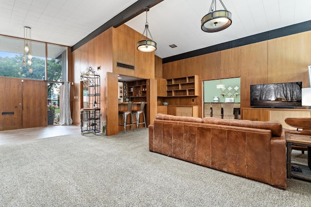 1240 Oakcrest Cir, Beaumont, TX 77706 - living room with expansive windows, wooden walls, and carpet floors