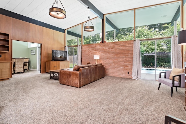 1240 Oakcrest Cir, Beaumont, TX 77706 - living area with carpet floors, wooden walls, and brick wall