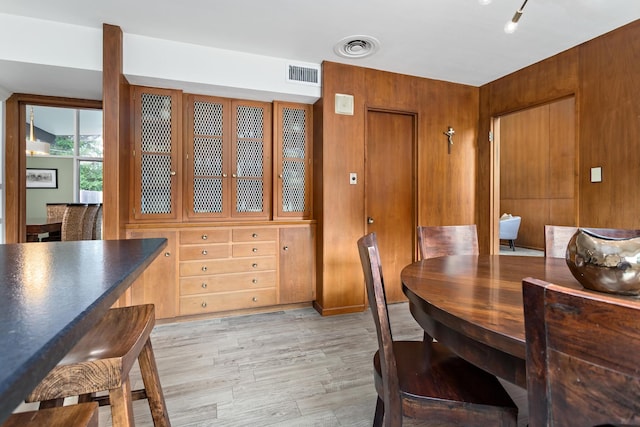 1240 Oakcrest Cir, Beaumont, TX 77706 - dining area featuring light wood-style floors and wood walls