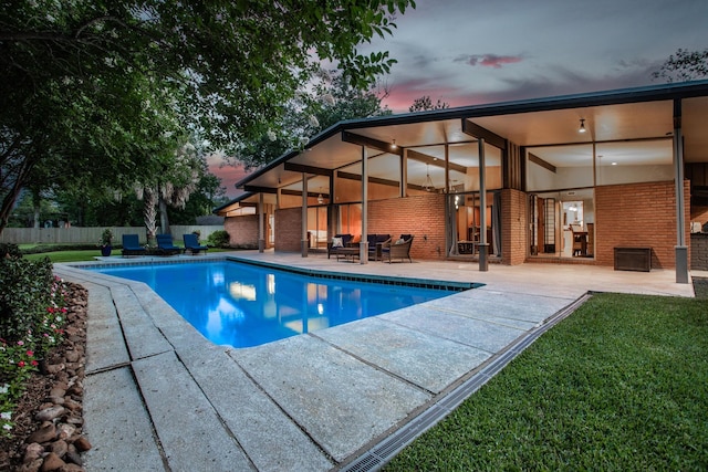 1240 Oakcrest Cir, Beaumont, TX 77706 - pool at dusk with a patio area and an outdoor living space