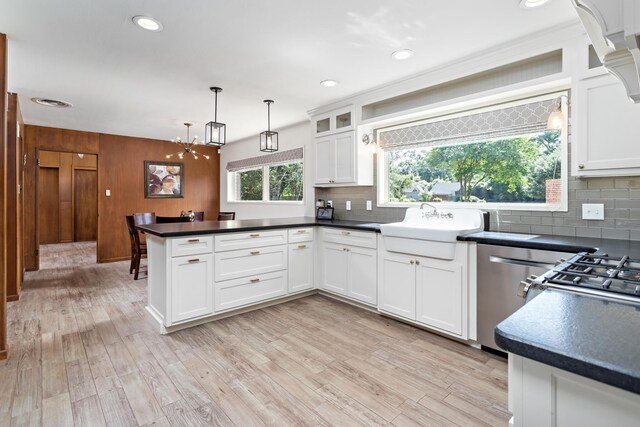 1240 Oakcrest Cir, Beaumont, TX 77706 - kitchen featuring a peninsula, decorative backsplash, dark countertops, white cabinets, and recessed lighting