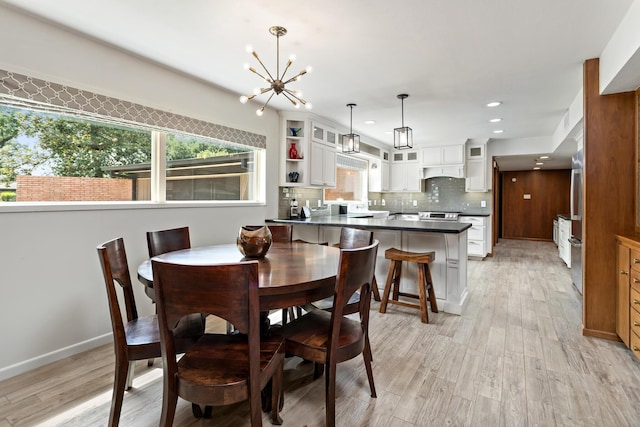 1240 Oakcrest Cir, Beaumont, TX 77706 - dining space with light wood-type flooring, a chandelier, and recessed lighting