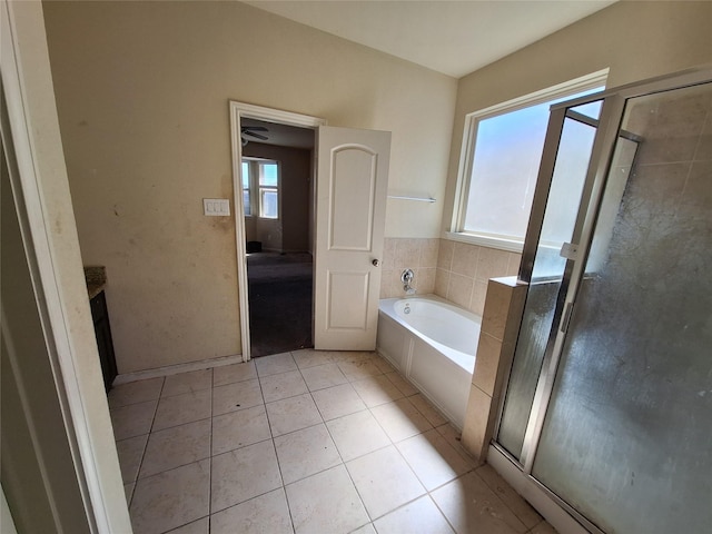 2419 Fort Baldy Trl, Humble, TX 77396 - bathroom featuring a bath, plenty of natural light, tile patterned flooring, and a stall shower