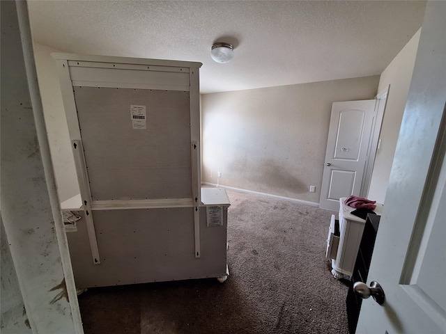 2419 Fort Baldy Trl, Humble, TX 77396 - spare room featuring carpet, baseboards, and a textured ceiling