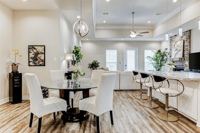 321 Twin Timbers Ln, Kemah, TX 77565 - dining area with light wood-style flooring, a raised ceiling, ceiling fan, crown molding, and recessed lighting