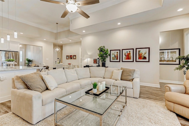 321 Twin Timbers Ln, Kemah, TX 77565 - living room featuring light wood finished floors, baseboards, a ceiling fan, recessed lighting, and a raised ceiling
