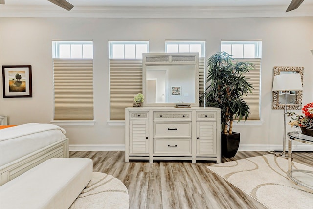 321 Twin Timbers Ln, Kemah, TX 77565 - bedroom with light wood-style flooring, ornamental molding, multiple windows, and baseboards