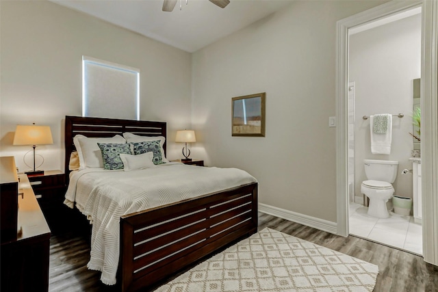 321 Twin Timbers Ln, Kemah, TX 77565 - bedroom with wood finished floors, baseboards, connected bathroom, and ceiling fan