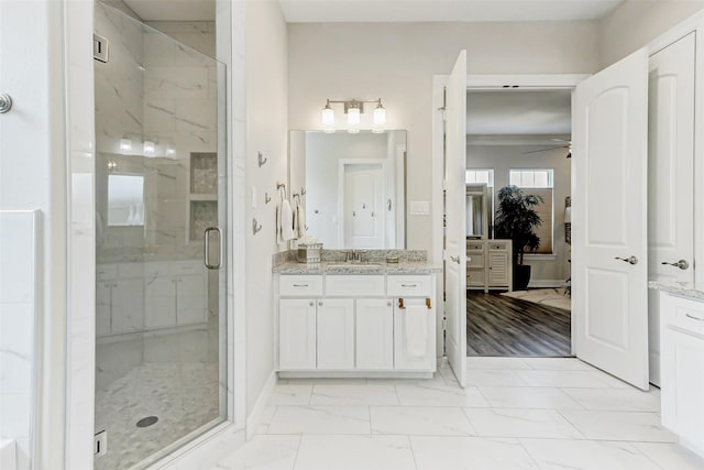 321 Twin Timbers Ln, Kemah, TX 77565 - bathroom with vanity, a shower stall, ceiling fan, marble finish floors, and baseboards