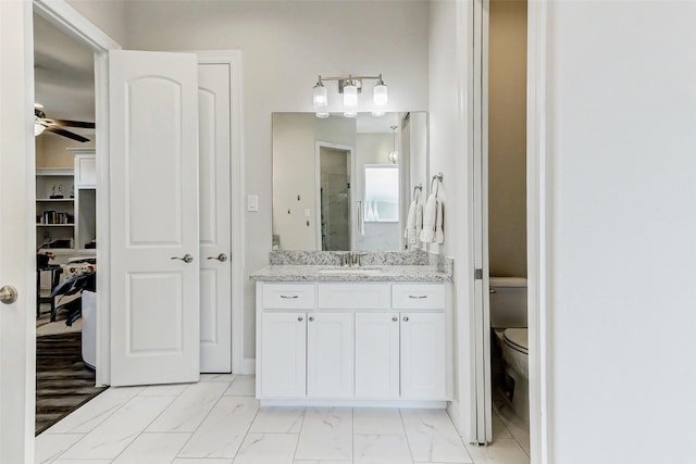 321 Twin Timbers Ln, Kemah, TX 77565 - bathroom with marble finish floors, a stall shower, vanity, toilet, and a ceiling fan