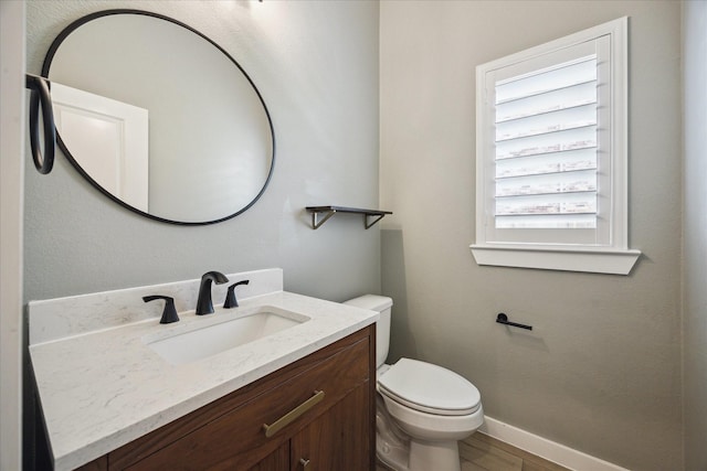 23910 Birchwood Lake Ln, Katy, TX 77493 - bathroom featuring toilet, vanity, baseboards, and wood finished floors