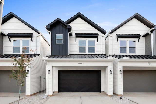 3848 Seabrook St, Houston, TX 77021 - view of front of home with a garage, a standing seam roof, concrete driveway, metal roof, and board and batten siding