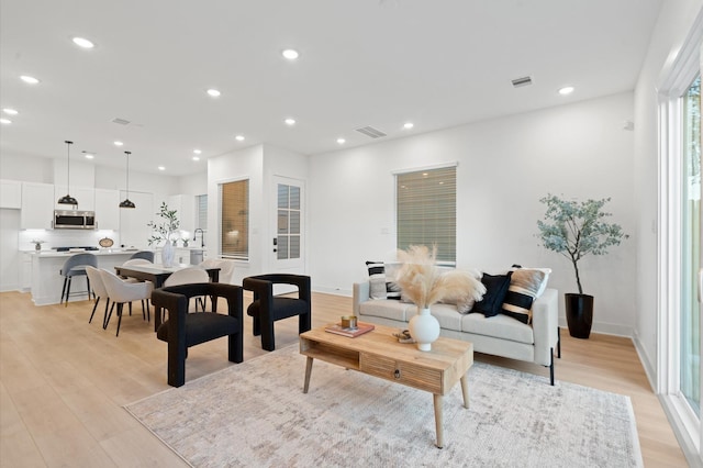 3848 Seabrook St, Houston, TX 77021 - living room with light wood finished floors, recessed lighting, and baseboards