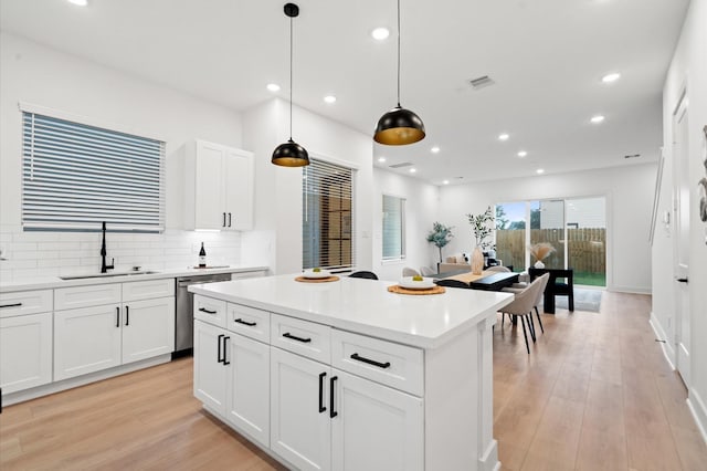 3848 Seabrook St, Houston, TX 77021 - kitchen with a sink, dishwasher, tasteful backsplash, a center island, and light wood-style floors