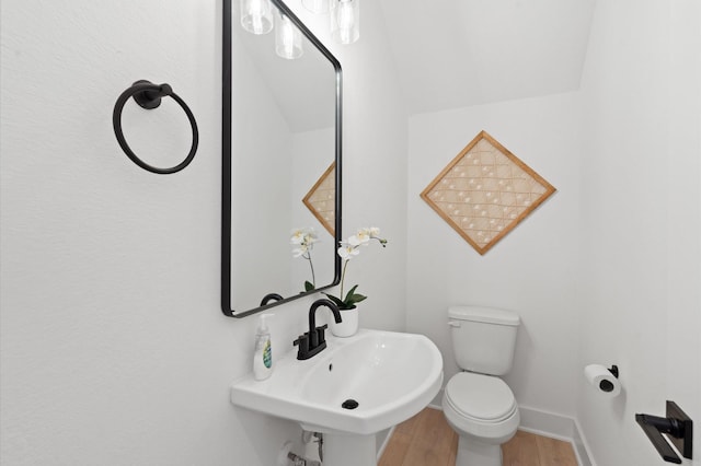 3848 Seabrook St, Houston, TX 77021 - half bathroom featuring wood finished floors, toilet, baseboards, and a sink