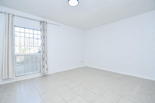 12251 Sharpview Dr, Houston, TX 77072 - unfurnished room with brick wall and baseboards