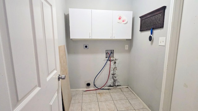 2014 Lexington Woods Dr, Spring, TX 77373 - laundry room featuring washer hookup, electric dryer hookup, cabinet space, light tile patterned floors, and baseboards