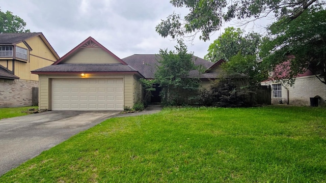 2014 Lexington Woods Dr, Spring, TX 77373 - view of front of house with a front yard, driveway, a garage, and a shingled roof