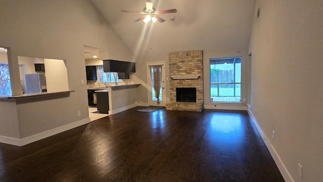 2014 Lexington Woods Dr, Spring, TX 77373 - unfurnished living room featuring ceiling fan, high vaulted ceiling, dark wood-style floors, baseboards, and a fireplace