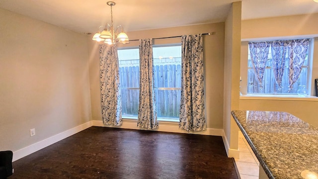 2014 Lexington Woods Dr, Spring, TX 77373 - unfurnished dining area featuring a chandelier, wood finished floors, and baseboards