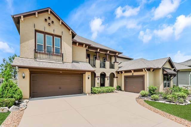 27415 Ashford Sky Ln, Katy, TX 77494 - mediterranean / spanish-style house with stucco siding, driveway, a balcony, and an attached garage