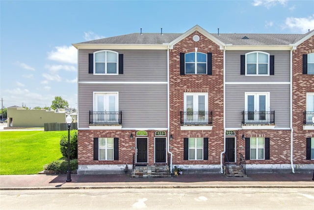 620 Cathedral Sq, Beaumont, TX 77701 - townhome / multi-family property featuring entry steps, brick siding, and a front yard