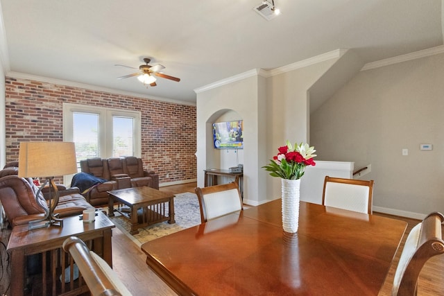 620 Cathedral Sq, Beaumont, TX 77701 - dining area featuring a ceiling fan, brick wall, wood finished floors, crown molding, and baseboards